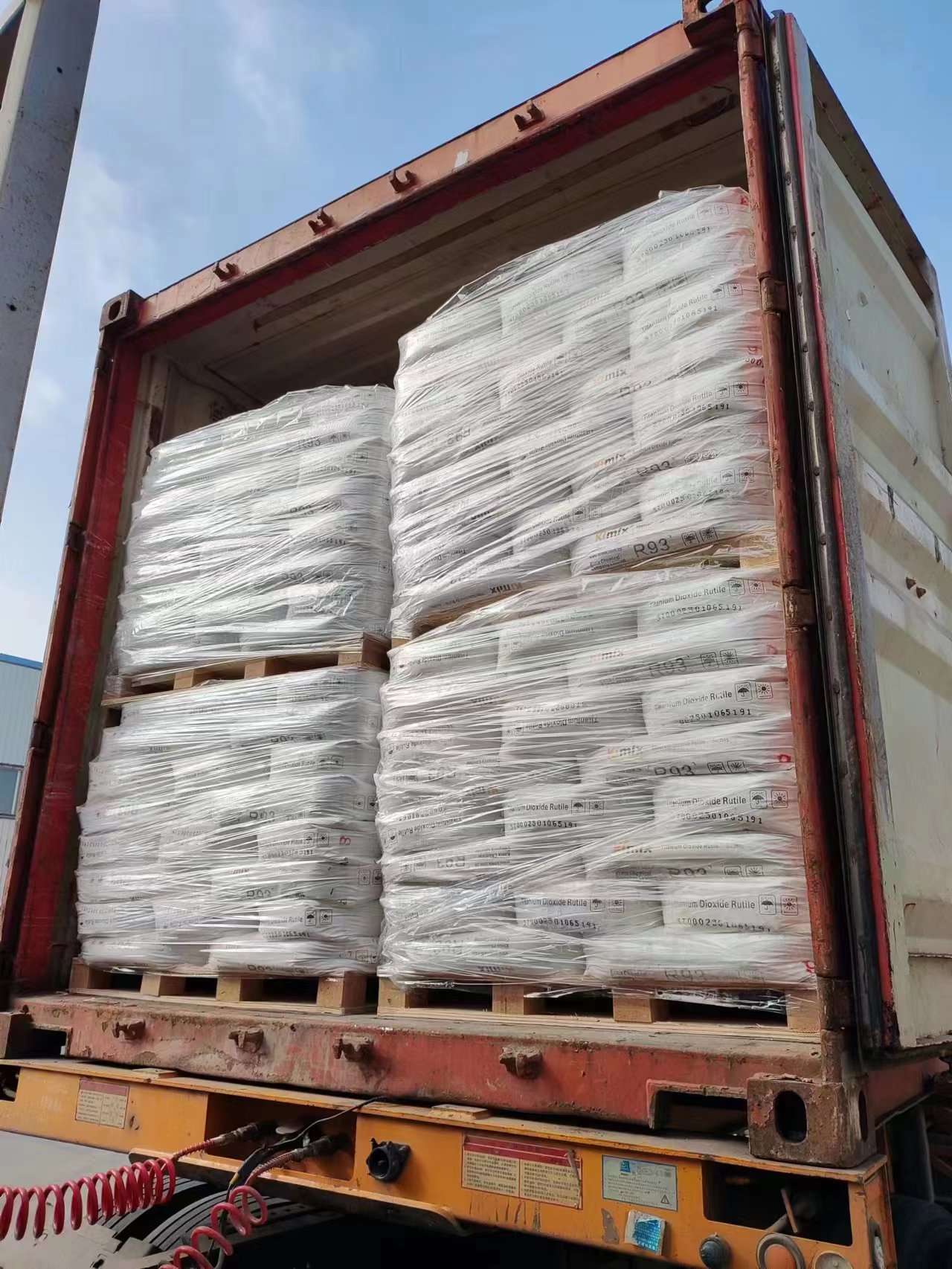 Palletized bagged material being loaded into a shipping container